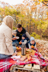 Naklejka na ściany i meble Family had a picnic while relaxing in the woods by the lake. Family member care concept. Autumn landscape.