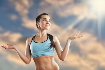 Portrait of fit woman smiling with perfect body relaxing after gym training