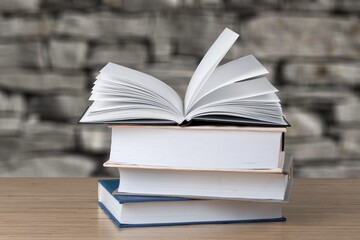 Study books stacked on a wooden desk