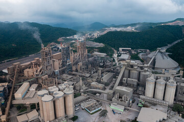 Aerial view of cement factory tower with high concrete plant structure at industrial production...