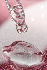 Cosmetic pipette with a pink on dark background.