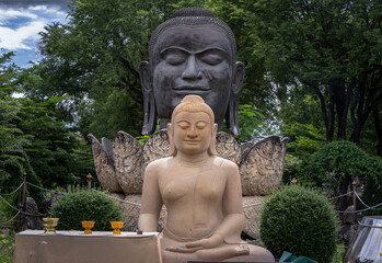 Aytthaya, Thailand, 22 Aug 2020 : Buddha statue and Head of the big black bronze buddha statue in the lotus flower closeup. Ancient sculpture in the buddhist temple of Wat Thammikarat. Ayutthaya, Thai