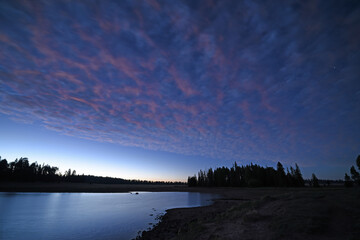 Night falls over a forest lake