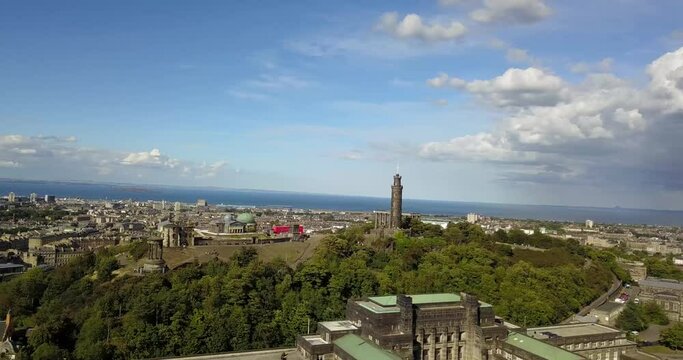 Beautiful drone footage above Edinburgh Scotland on a stunning summer day. Blue skies over high road, edinburgh castle, aurthur's seat and the entire city. rare, new footage, 4k gradable.
