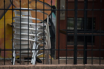 Stack of metal chairs in closed cafe in SoCo