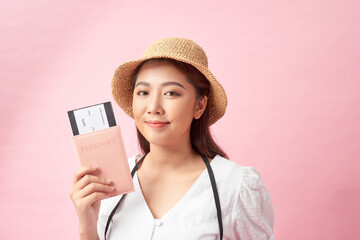 a happy young asian woman dressed in white dress and summer hat holding photo camera