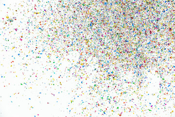 Small fragments of colorful paper pieces spill out in air as beautiful celebration flakes and vivid flares to entertain and decorate party