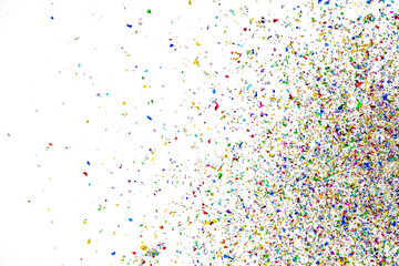 Small fragments of colorful paper pieces spill out in air as beautiful celebration flakes and vivid flares to entertain and decorate party