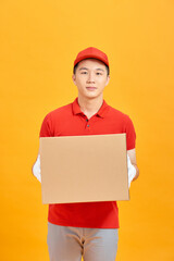 Portrait of a male delivery man holding a cargo box, background