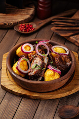 Fototapeta na wymiar Georgian national dish ojahuri with meat on wooden background