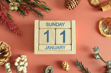 January 11, Cover design with calendar cube, pine cones and dried fruit in the natural concept.	
