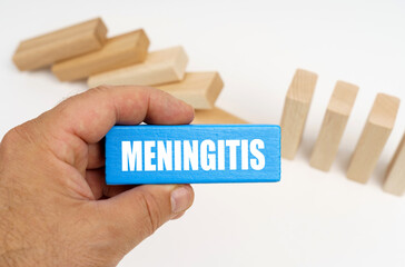 The man is holding a blue plaque with the inscription - Meningitis