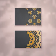 Business card template in black with Greek gold pattern for your business.