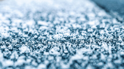 Frosting macro. Cold snow winter background. Blue crystal frozen abstract pattern. White frost ice texture.