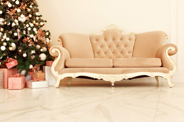 Festive interior: christmas tree and sofa with pillows, gifts. The concept of Christmas and the New year.