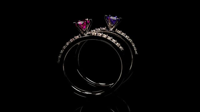 Gold ring with diamond gem jewelry. Luxury jewelry bijouterie with crystal gemstone rolling on a mirror surface. Frontal view and reflection on black background. 3D rendering.
