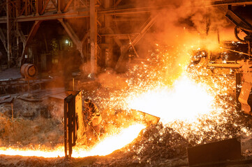 Blast furnace, cast iron production. Metal poured out of the metallurgical furnace