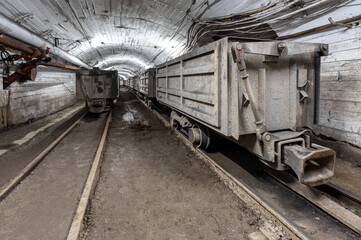 Underground mine railway for transporting ore. Freight trolleys and wagons