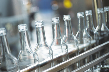 Row of glass bottles to fill with expensive alcohol drinks