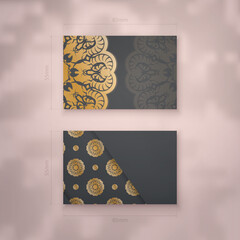 Business card template in black with a gold mandala pattern for your contacts.
