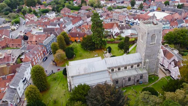 Aerial St Michael's Church at residential area in Framlingham, England - drone tracking shot