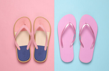 Colored flip flops on blue pink pastel background