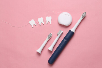 Obraz na płótnie Canvas Dental care concept. Toothbrush, dental floss with teeth on pink background. Top view. Flat lay