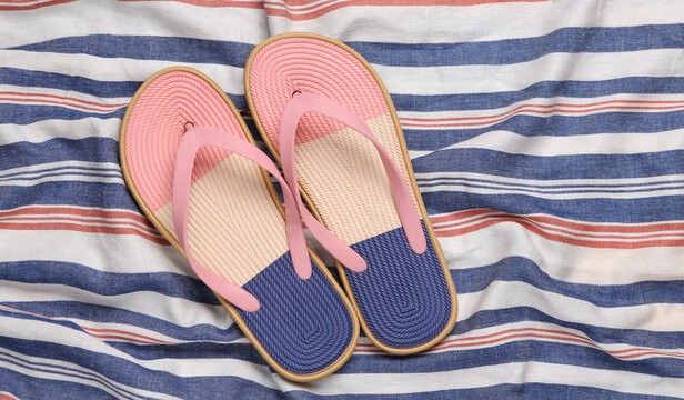 Flip flops on a striped surface. Beach vacation concept
