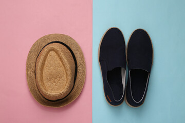 Mens straw hat and shoes on blue pink pastel background. Top view. Flat lay