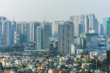 Metro Manila, Philippines - April 2021: Ortigas and Boni skyline contrast a dense and less affluent...