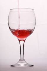 red wine is poured into a glass