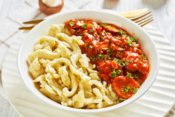 spaetzle with mushroom gravy in a white bowl