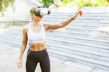 Fitness woman with virtual reality helmet outdoors
