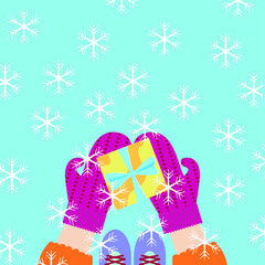 Vector graphics - a square greeting card with hands in bright mittens holding a gift box with a bow on the background of falling snowflakes. Concept Christmas and New Year