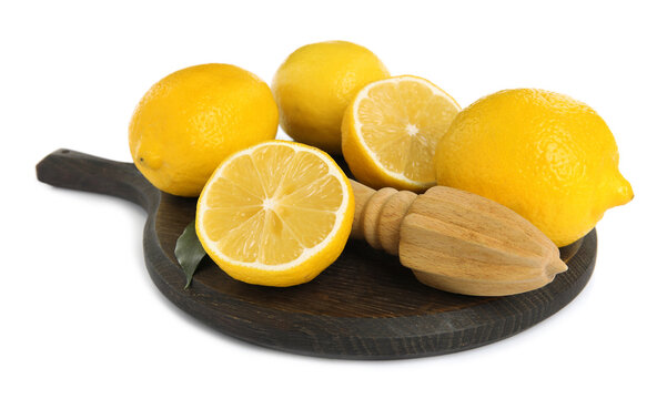 Wooden citrus reamer and fresh lemons on white background