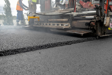 Laying the next layer of asphalt in the construction of a new road Tavrida in the Crimea. The crossing of roads is equipped with safe bridge crossings. Special machinery