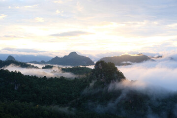 Fototapeta na wymiar Beautiful mountain sunrise with sunlight and fog over northern Thailand's mountains
