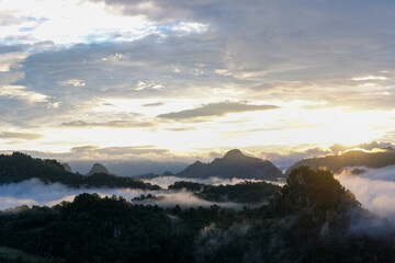 Beautiful mountain sunrise with sunlight and fog over northern Thailand's mountains