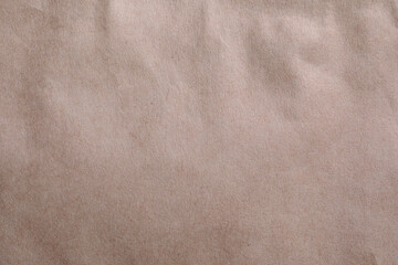 Fototapeta na wymiar Texture of kraft paper bag as background, closeup