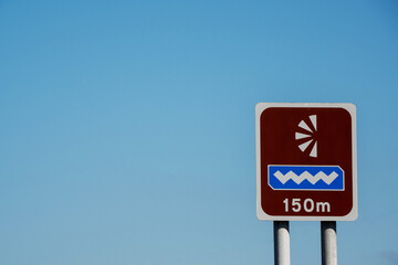 Simple view point sign with observation icon on brown color. Clean blue sky background. Copy space. 150 meters distance