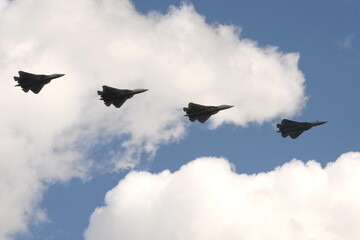 Fototapeta na wymiar Russian multi-purpose fighters of the fifth generation Su-57 in the sky over Moscow's Red Square during the dress rehearsal of the Victory Air Parade