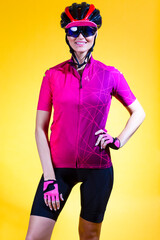Female Cycling Ideas. Portrait of Positive Female Road Cyclist in Professional Sport Outfit Posing Against Yellow Background.