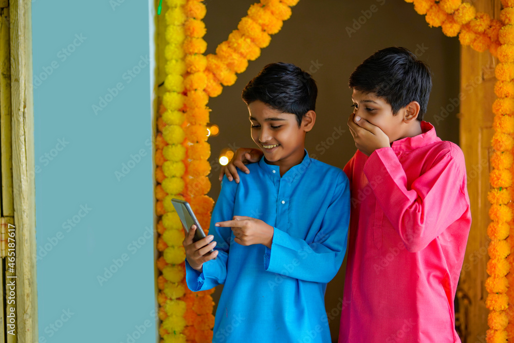 Wall mural indian little boys using smartphone and enjoying diwali festival.