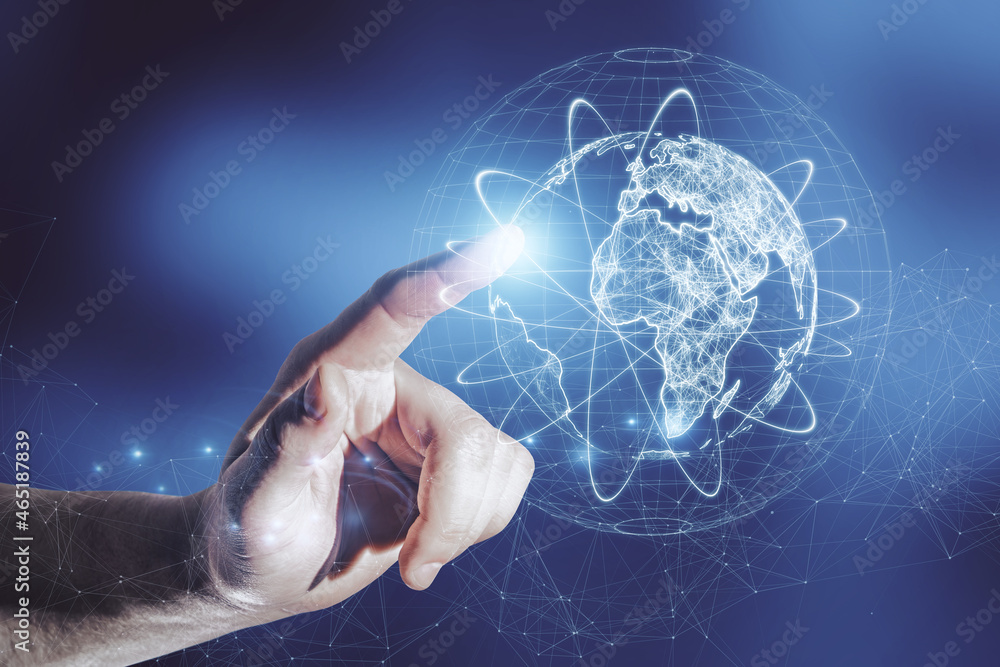 Poster close up of businessman hand pointing at abstract glowing globe hologram on blurry blue background. 