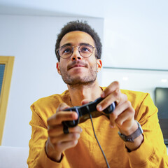 A young African playing a game of consoles © woff