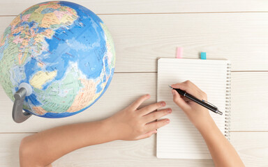 The child studying maps. The child learning about abroad. Geography, travel, maps, society,...