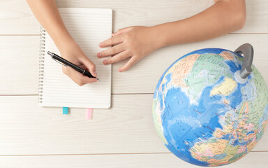 The child studying maps. The child learning about abroad. Geography, travel, maps, society,...