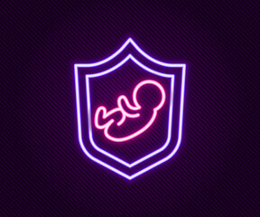 Glowing neon line Baby on shield icon isolated on black background. Child safety sign. Colorful outline concept. Vector