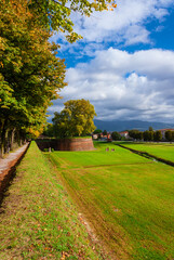 Fototapeta na wymiar Travel in Tuscany. The Walls of Lucca public park with St Salvador Bulwark