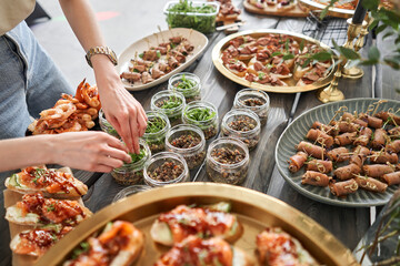 The waiter sets the table. Delicious fresh seafood, shrimp with fresh vegetables. buffet table with lots of delicious snacks.